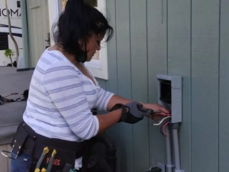 Licensed electrician wiring an exterior subpanel in Carver