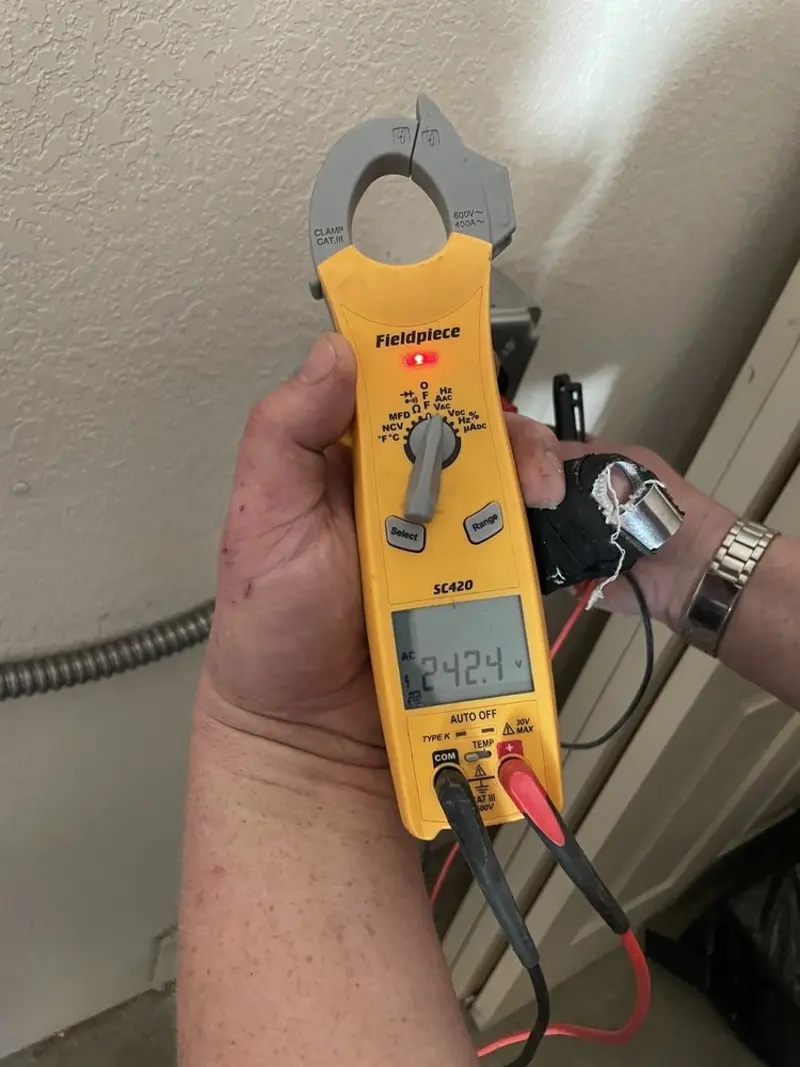 Voltage testing with clamp meter during Outlet Installation in Carver
